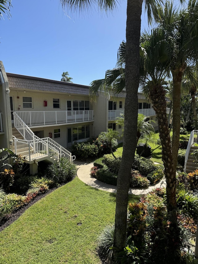 exterior space featuring stairway and a lawn