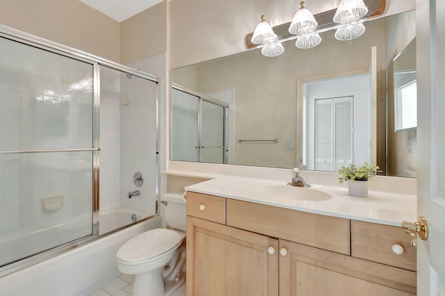 full bathroom with vanity, toilet, shower / bath combination with glass door, and tile patterned flooring