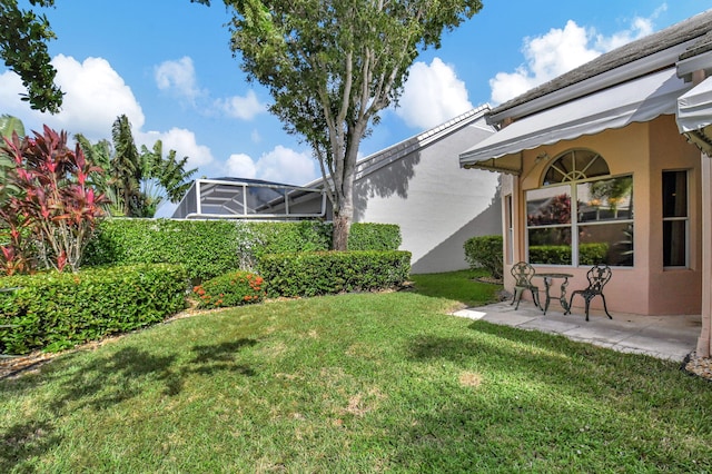 view of yard featuring a patio area and a lanai