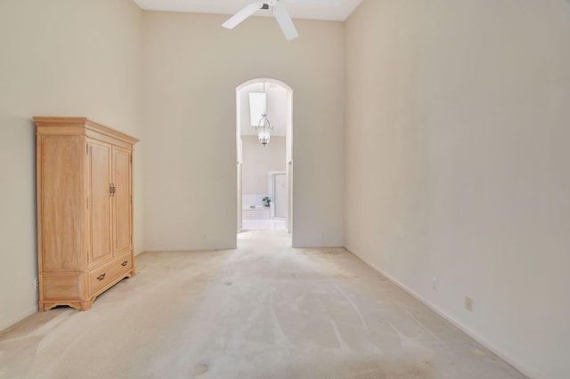 carpeted spare room featuring ceiling fan