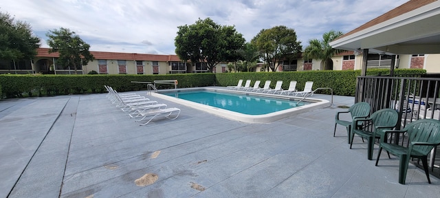 view of swimming pool with a patio