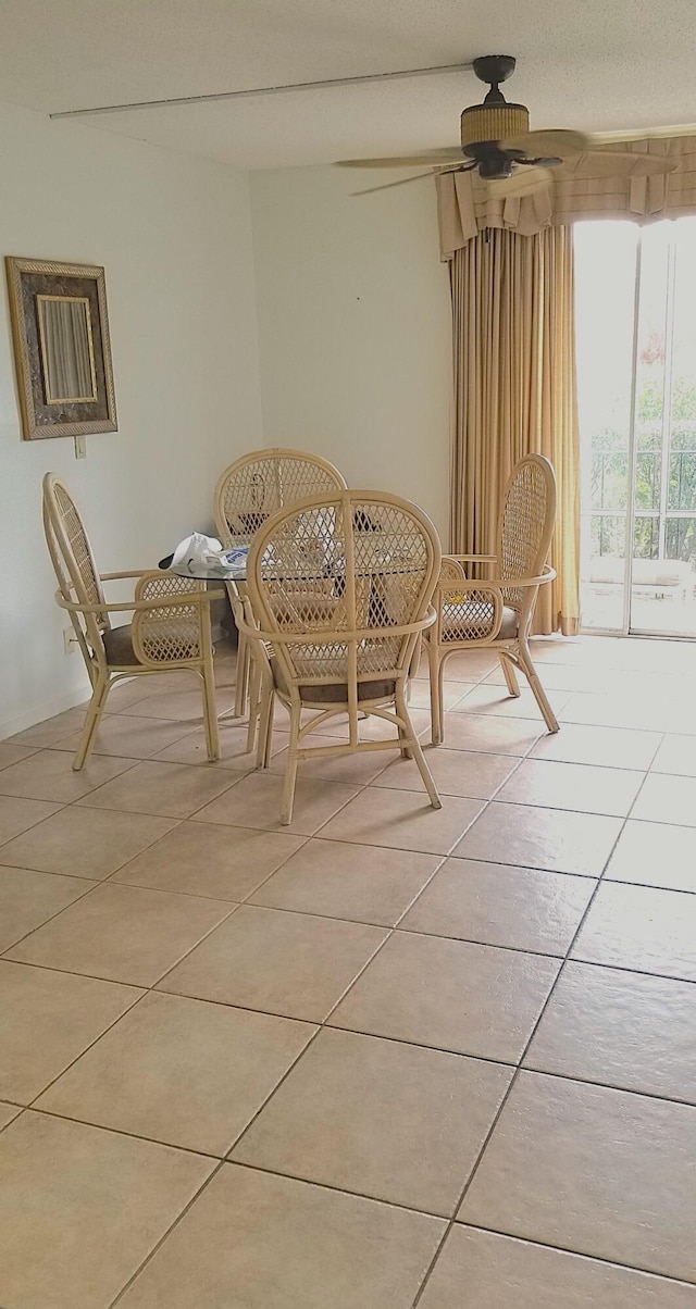 tiled dining area featuring ceiling fan