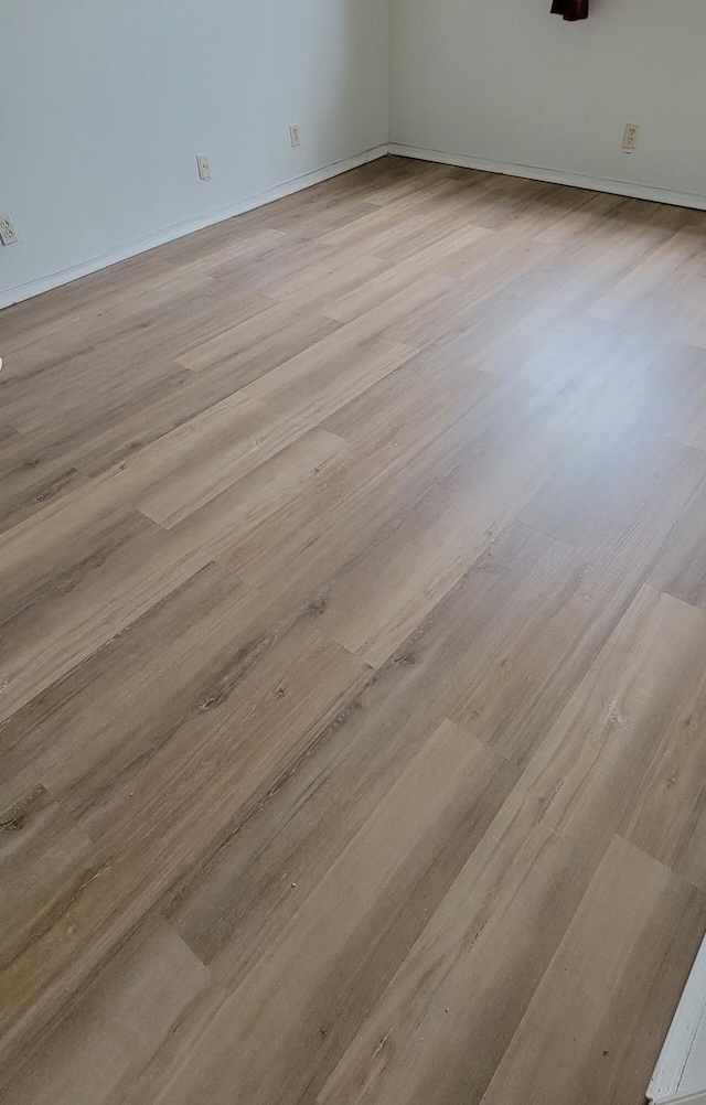 empty room with light hardwood / wood-style flooring