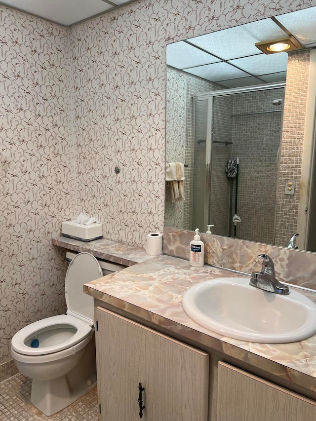 bathroom featuring toilet, walk in shower, vanity, and tile patterned flooring