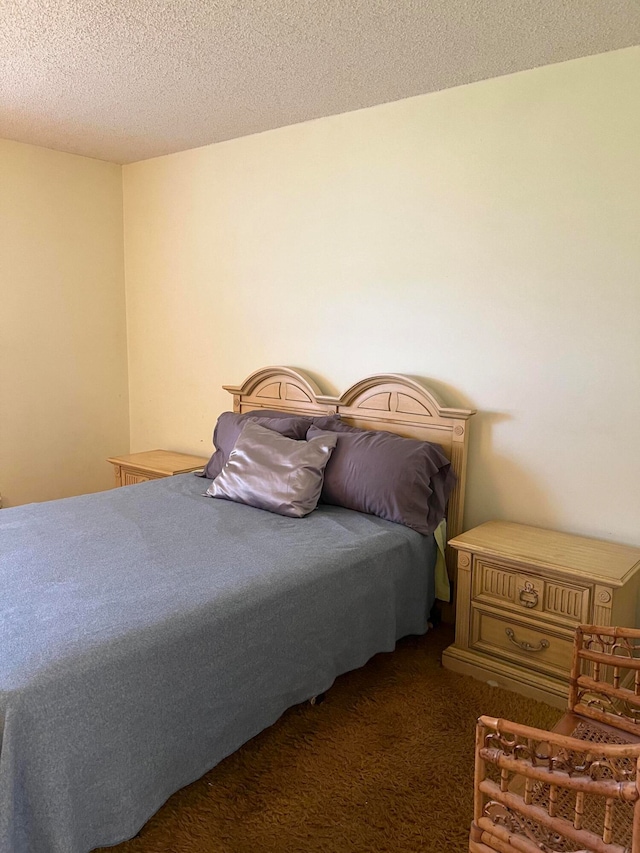 carpeted bedroom featuring a textured ceiling