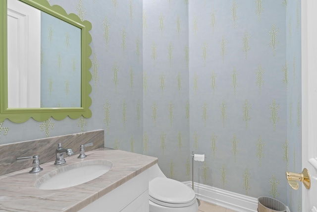 bathroom featuring toilet, tile patterned floors, and vanity