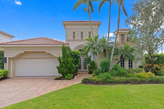 mediterranean / spanish-style house with a garage and a front yard