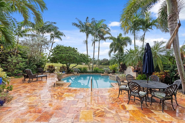 view of swimming pool with a patio area and a hot tub