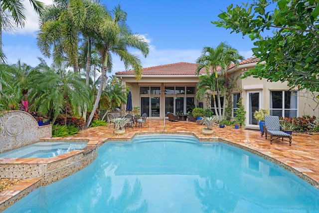 view of pool with an in ground hot tub and a patio