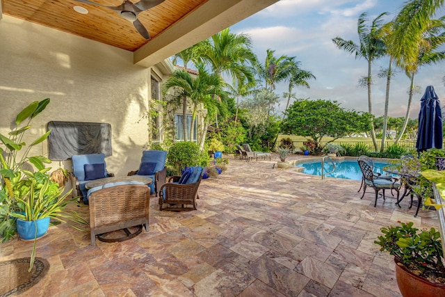 view of pool with ceiling fan, outdoor lounge area, and a patio