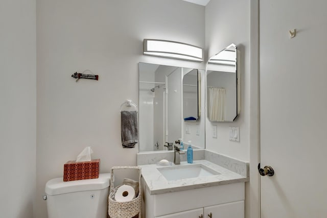 bathroom featuring vanity, toilet, and walk in shower