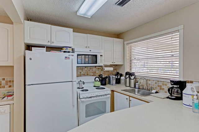 kitchen featuring white cabinets, sink, backsplash, and white appliances