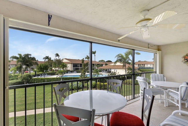 sunroom featuring ceiling fan