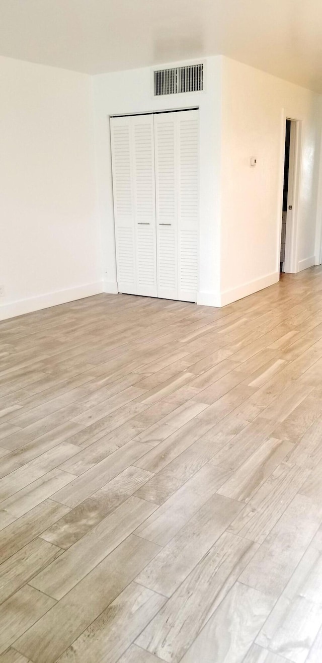 unfurnished room with light hardwood / wood-style flooring