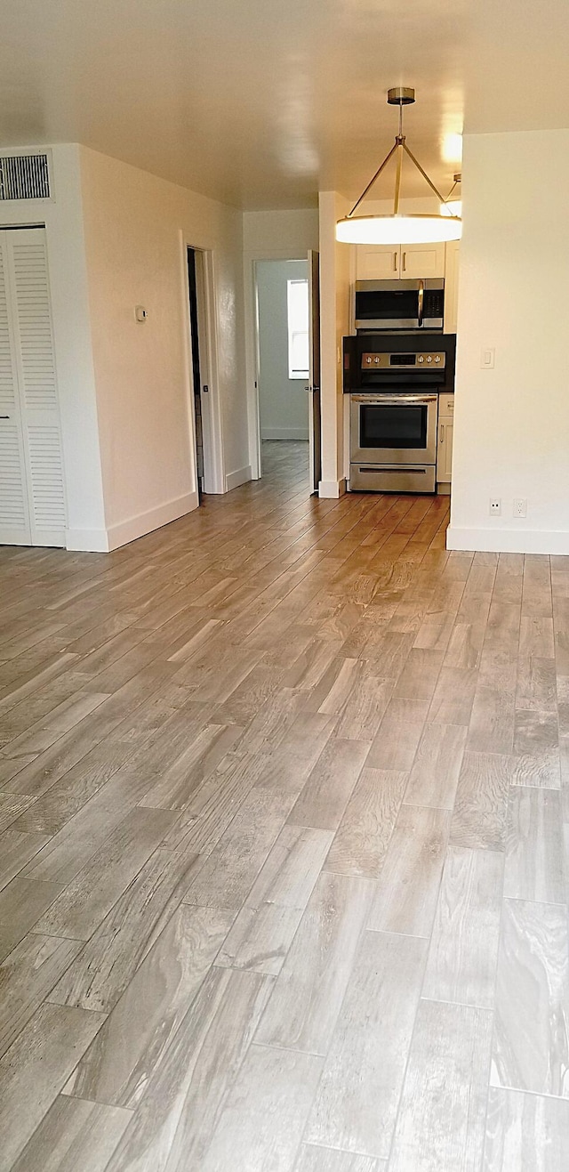 unfurnished living room featuring light wood-type flooring