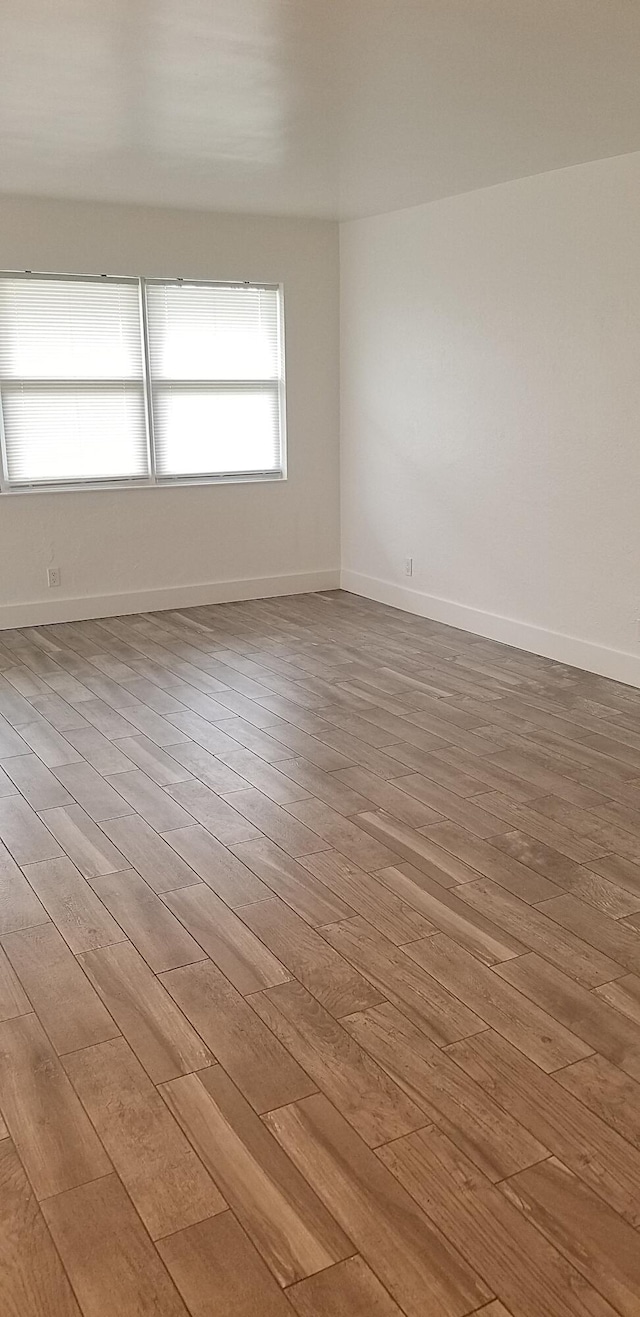 empty room with light hardwood / wood-style flooring