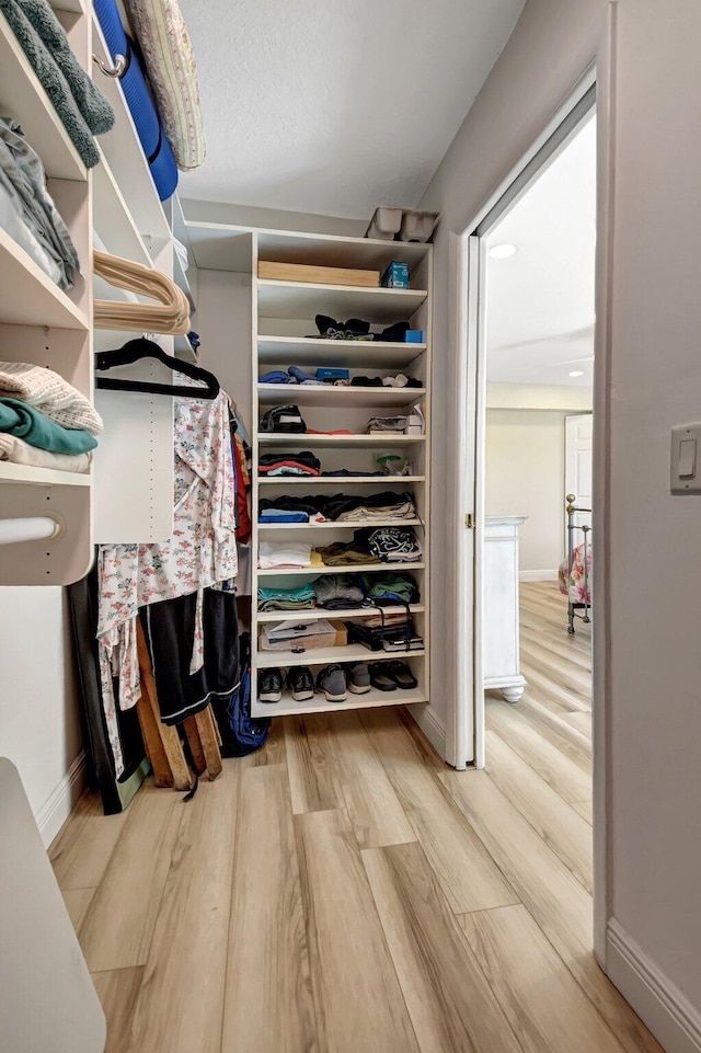 walk in closet featuring wood-type flooring