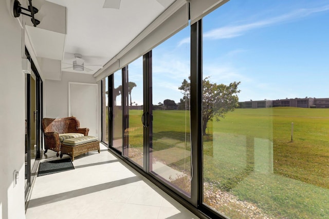 sunroom / solarium featuring ceiling fan