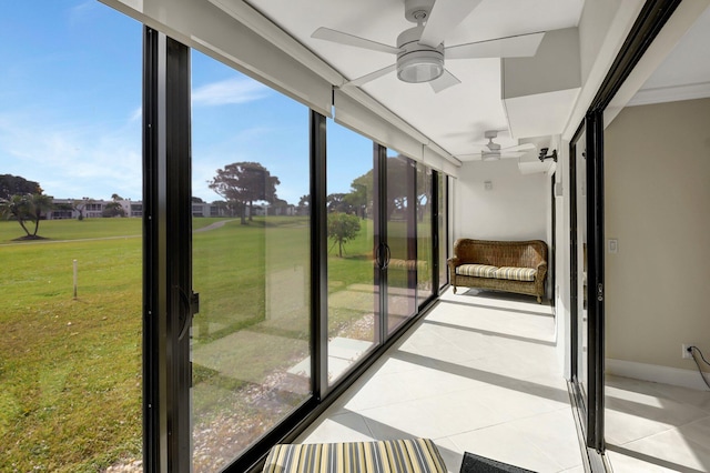 unfurnished sunroom featuring ceiling fan