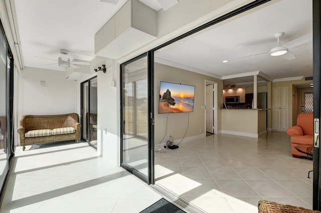 interior space featuring light tile patterned floors, ceiling fan, and ornamental molding