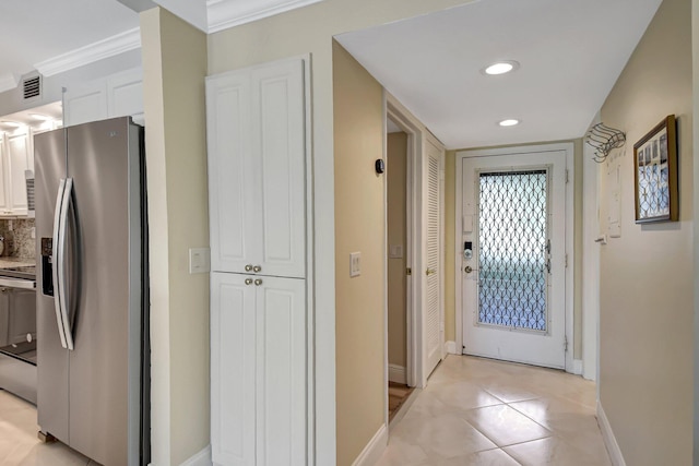 doorway to outside featuring crown molding and light tile patterned flooring