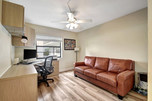 office with ceiling fan and light hardwood / wood-style flooring