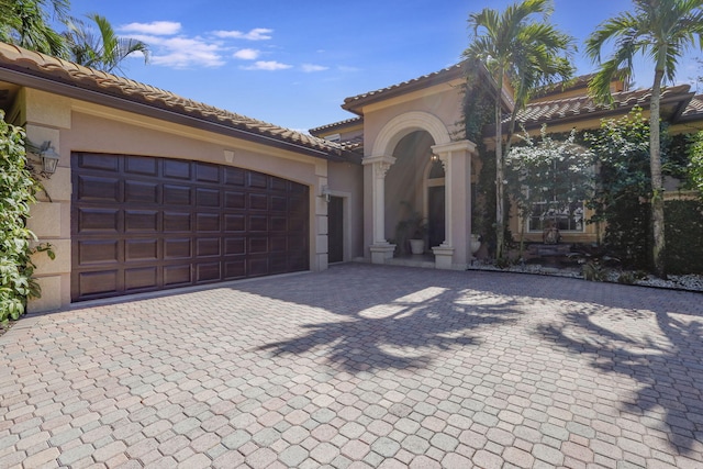 mediterranean / spanish home featuring a garage