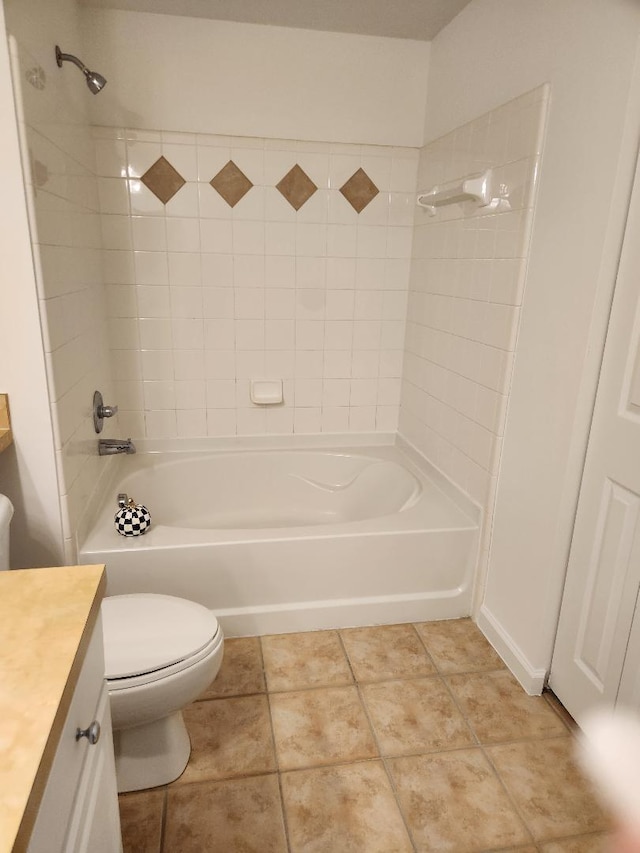 full bathroom with toilet, tiled shower / bath combo, vanity, and tile patterned floors