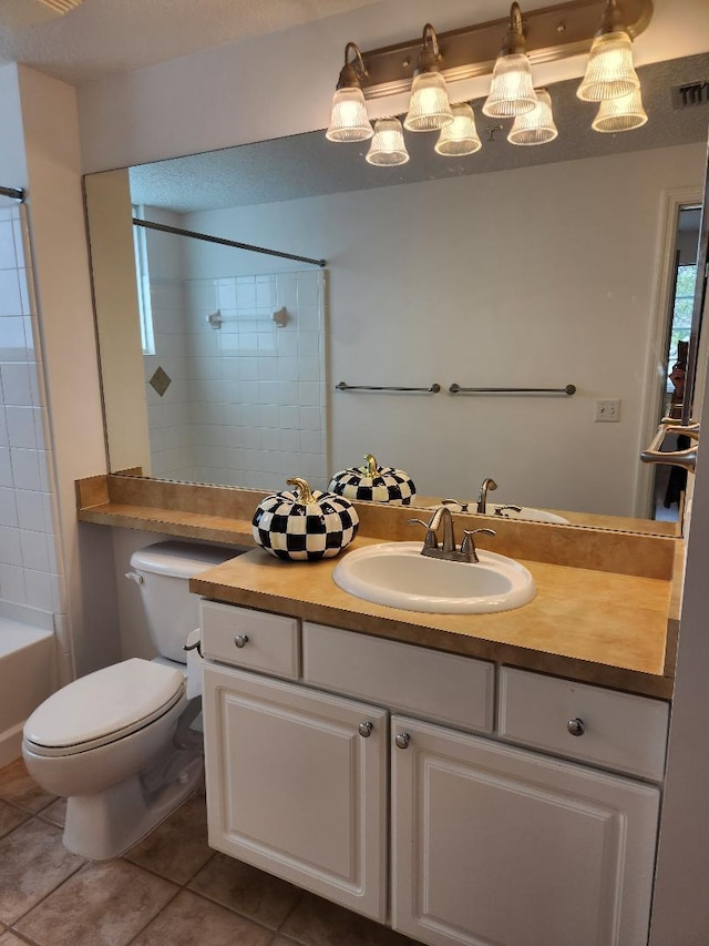 full bathroom featuring tile patterned flooring, vanity, toilet, and tiled shower / bath