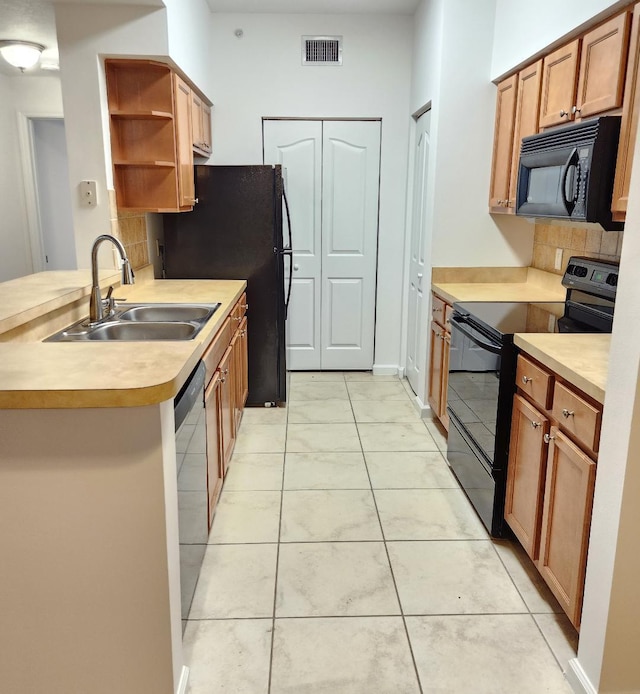 kitchen with light tile patterned flooring, sink, black appliances, kitchen peninsula, and decorative backsplash