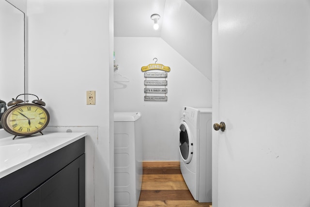 laundry room featuring washer and clothes dryer and dark wood-style flooring