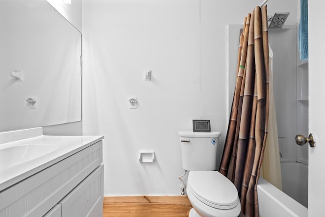 full bath featuring toilet, shower / bath combo, wood finished floors, and vanity