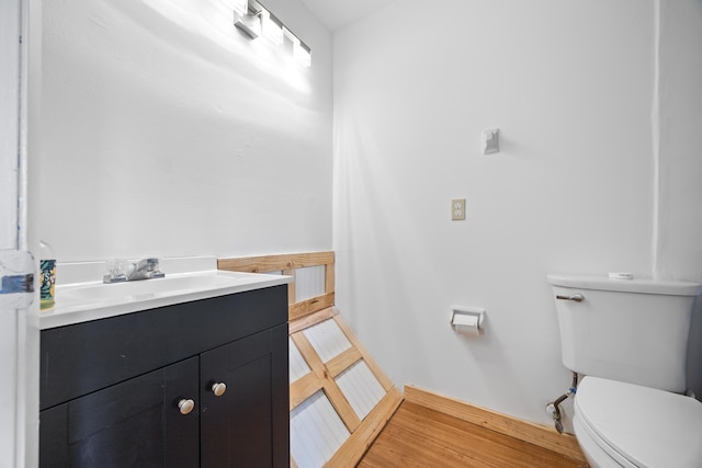 half bathroom with vanity and toilet