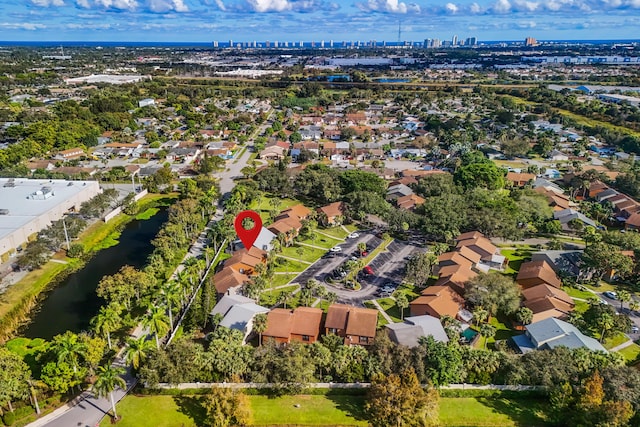 birds eye view of property with a water view, a residential view, and a city view