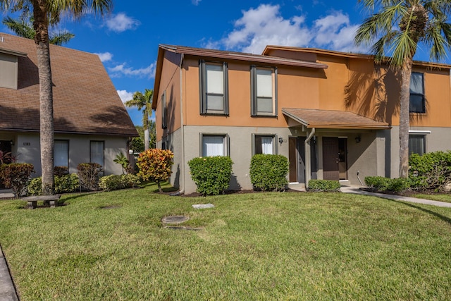 view of front of home featuring a front lawn and stucco siding