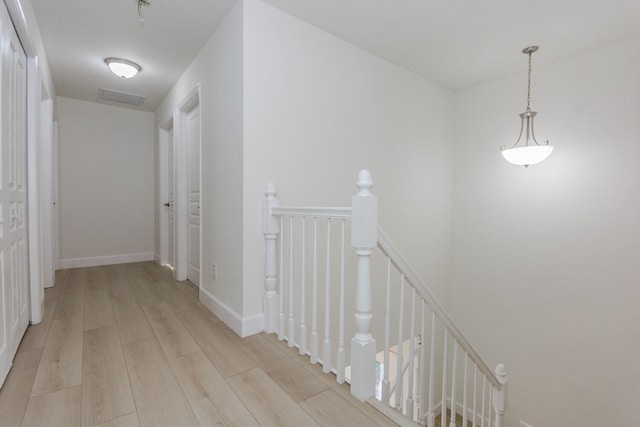 hallway with light hardwood / wood-style flooring