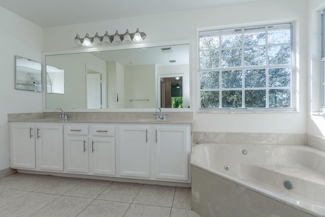 bathroom featuring tile patterned flooring, vanity, and a tub to relax in