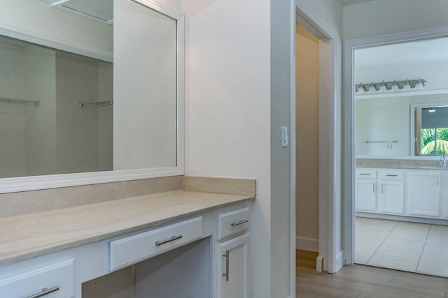 bathroom featuring hardwood / wood-style flooring and vanity