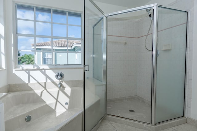 bathroom with independent shower and bath and tile patterned floors