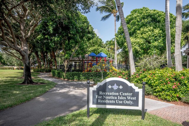 view of home's community with a playground and a yard