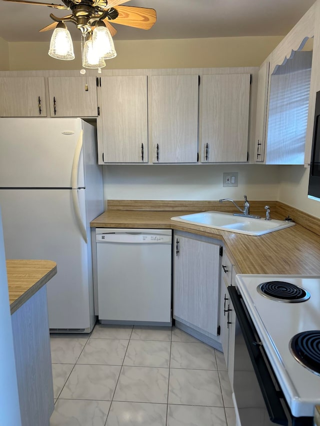 kitchen with light brown cabinets, ceiling fan, sink, and white appliances