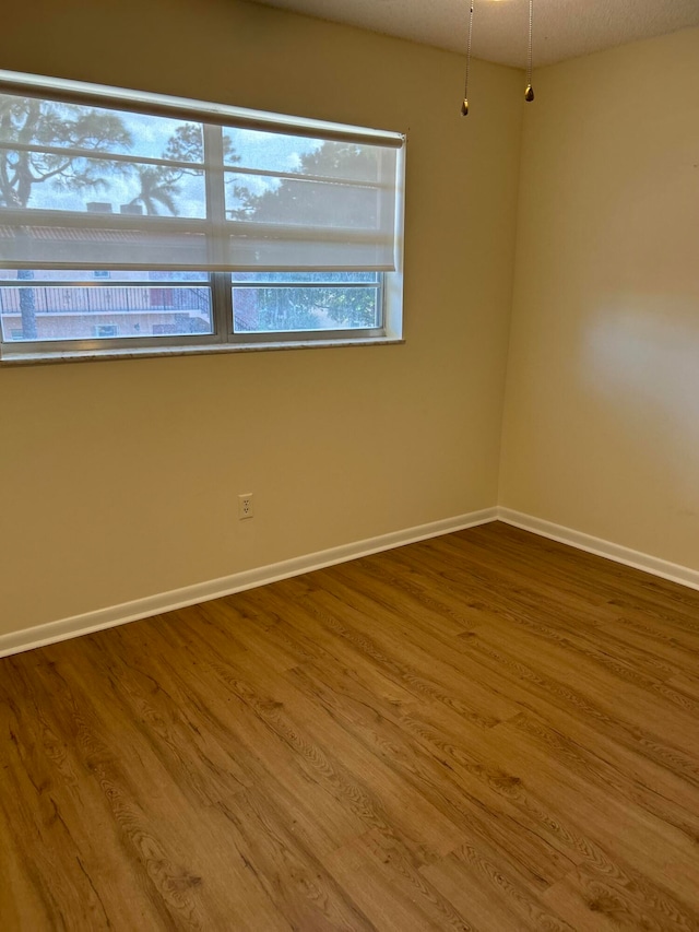 empty room featuring a textured ceiling and hardwood / wood-style flooring