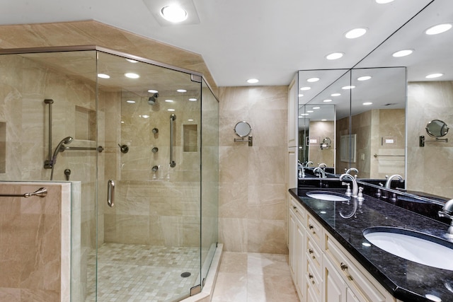 bathroom featuring vanity, tile patterned floors, and a shower with door