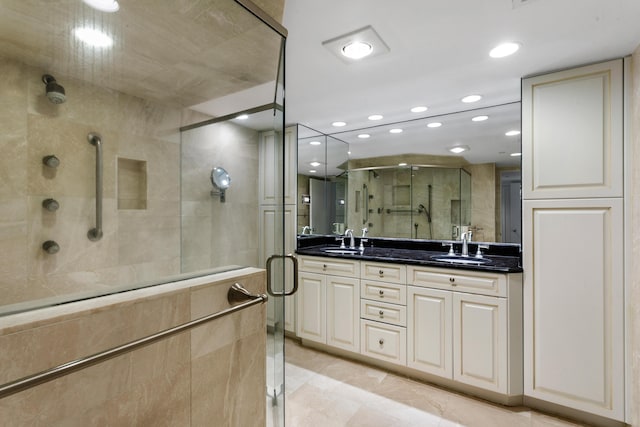 bathroom with tile patterned flooring, vanity, and walk in shower