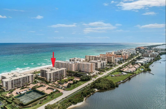 bird's eye view featuring a water view and a beach view