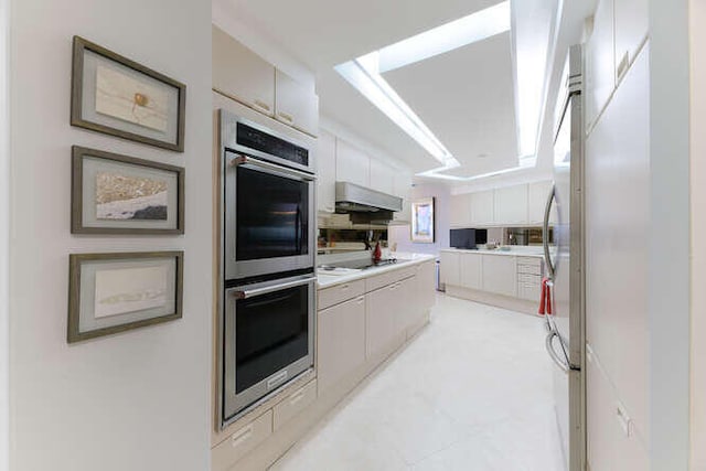 kitchen featuring white cooktop and double oven