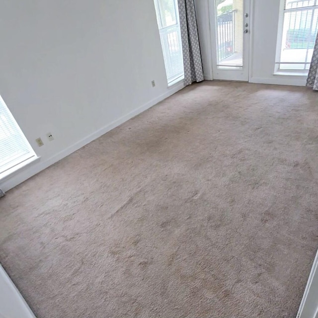 carpeted spare room with a wealth of natural light