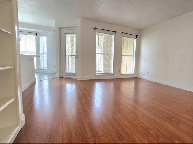 spare room featuring a wealth of natural light and light wood-type flooring