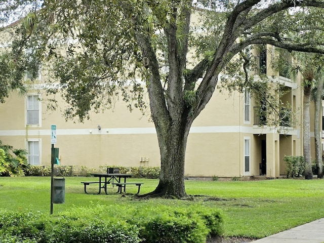 view of home's community with a lawn