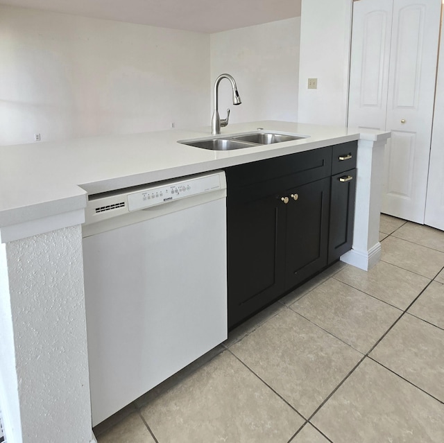 kitchen with white dishwasher, light tile patterned flooring, white cabinetry, and sink